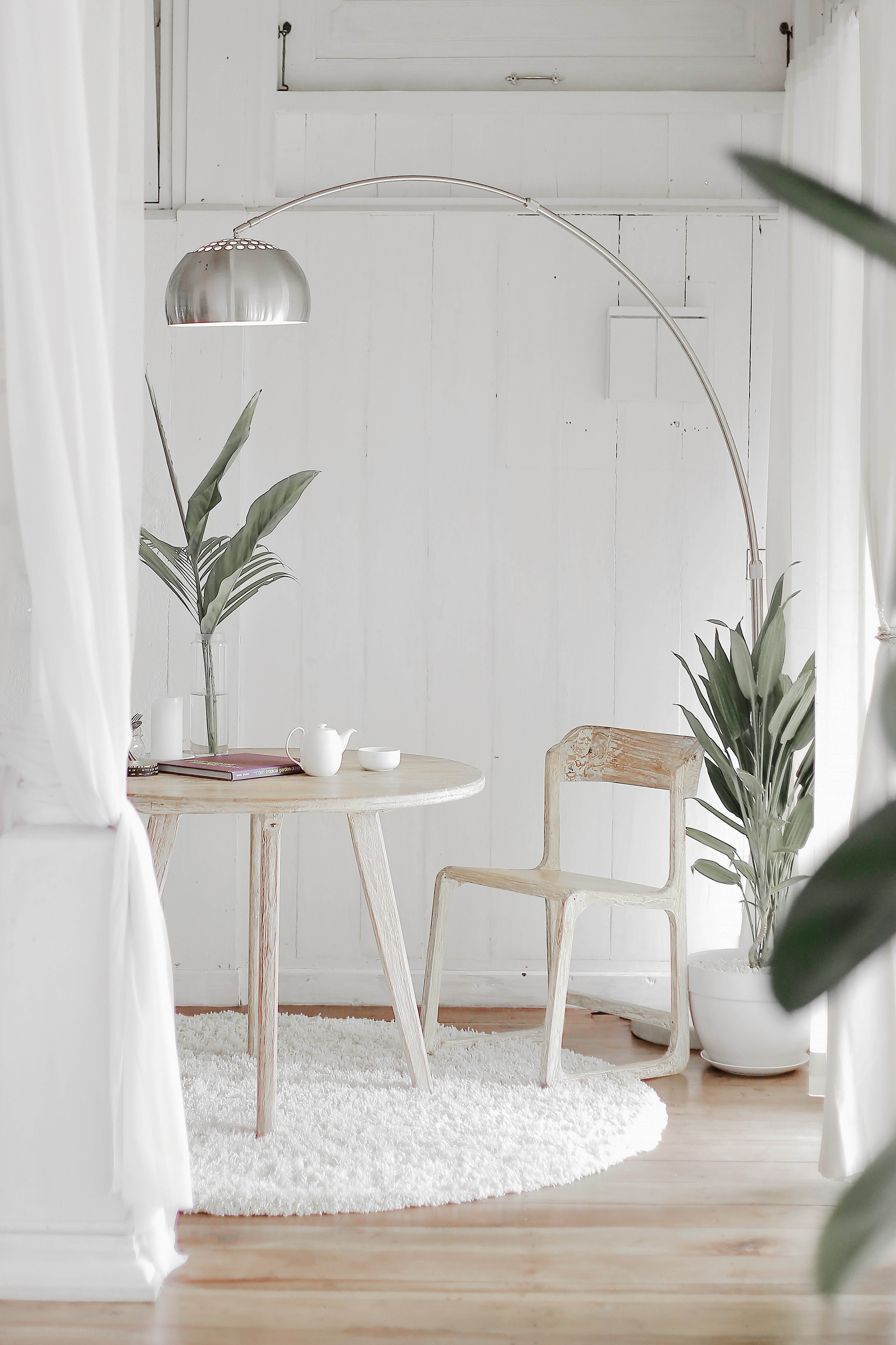 Scandinavian-Style Living Space with Wooden Table, Chair, and Indoor Plants